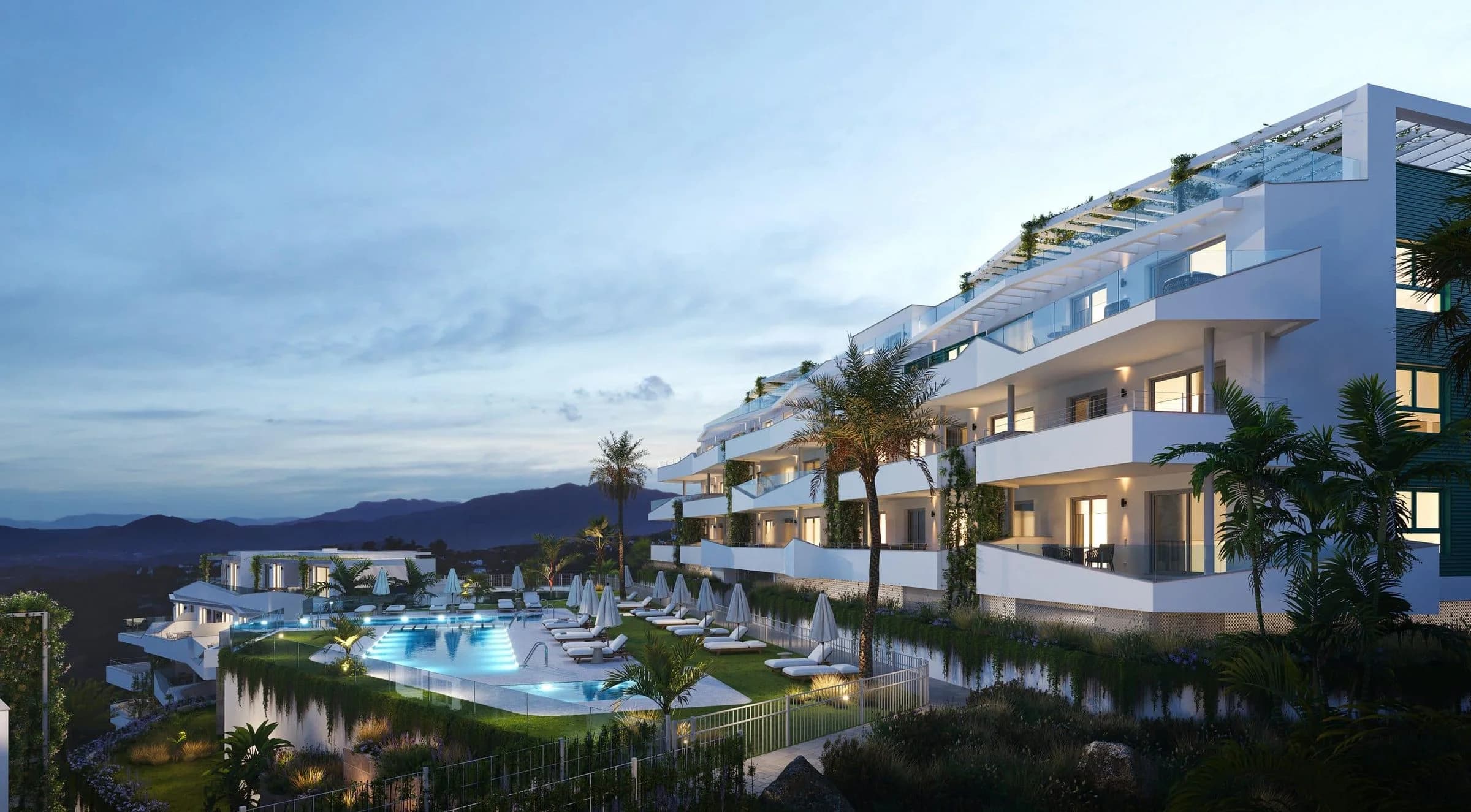 New-build apartment complex with terraces and a pool at dusk on the Costa del Sol